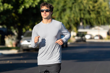 Athlete running outdoors in California wearing an IBKÜL Iceƒil® performance shirt while training for a half IRONMAN.