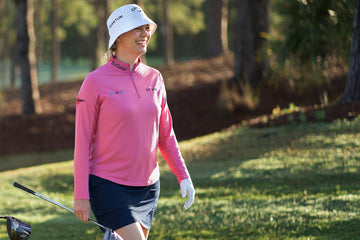 Golfer wearing an IBKÜL UPF 50+ long sleeve shirt outdoors on a cool fall day