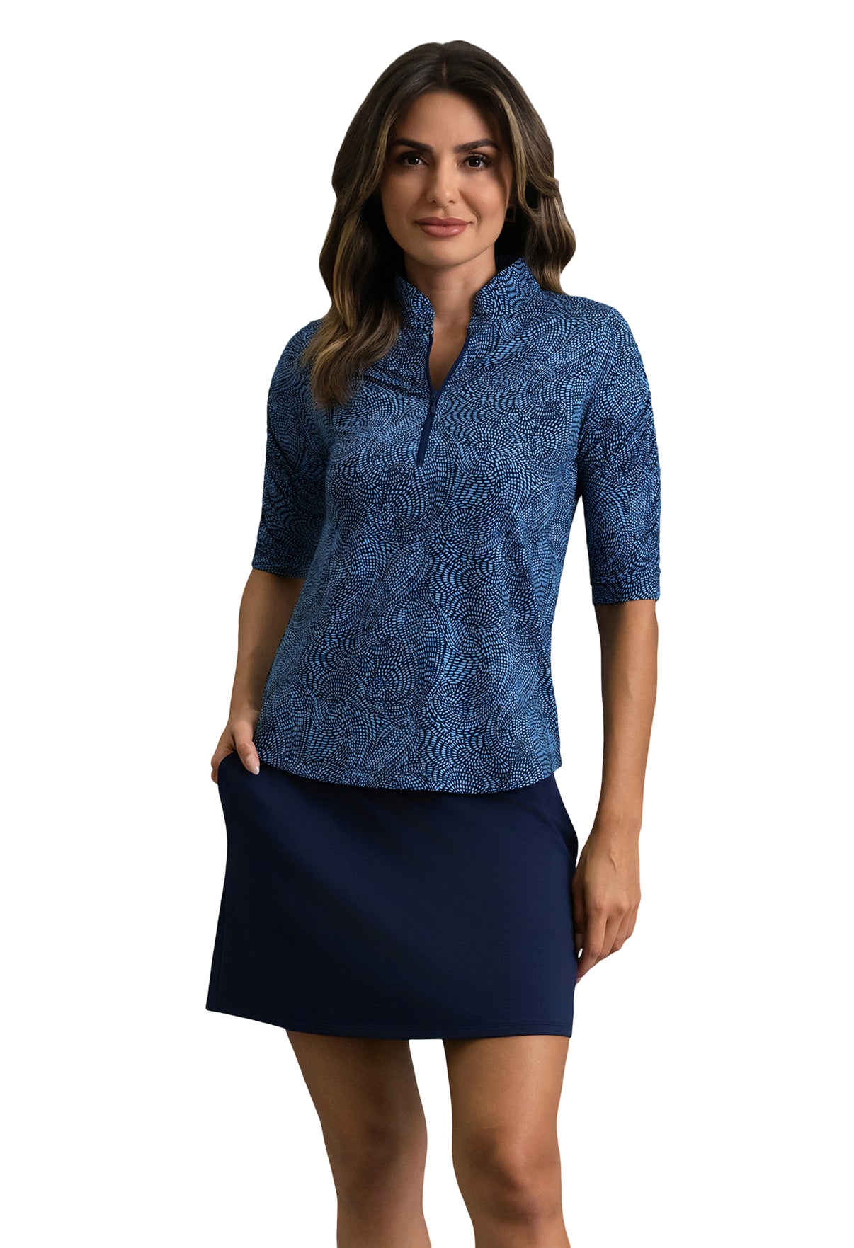 Woman wearing a blue patterned top and navy skirt on a white background