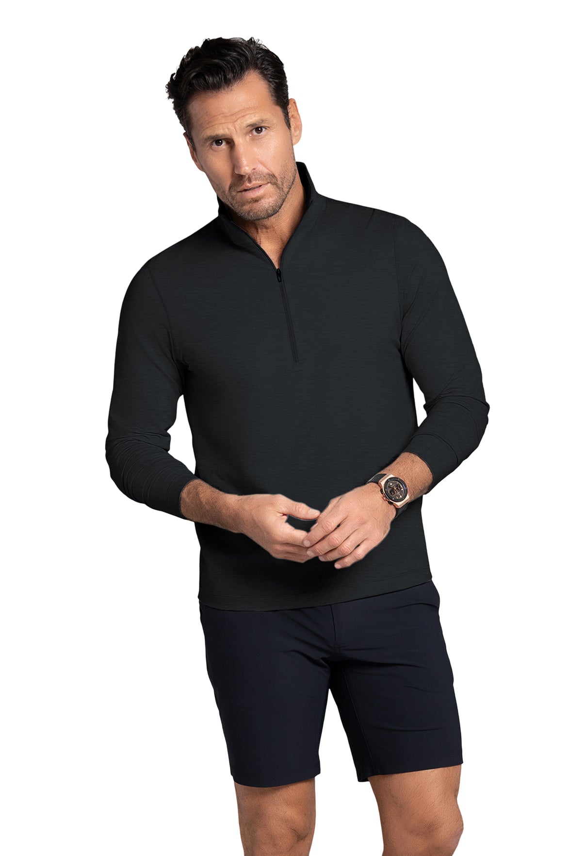 Man wearing a black long-sleeve shirt and black shorts on a white background