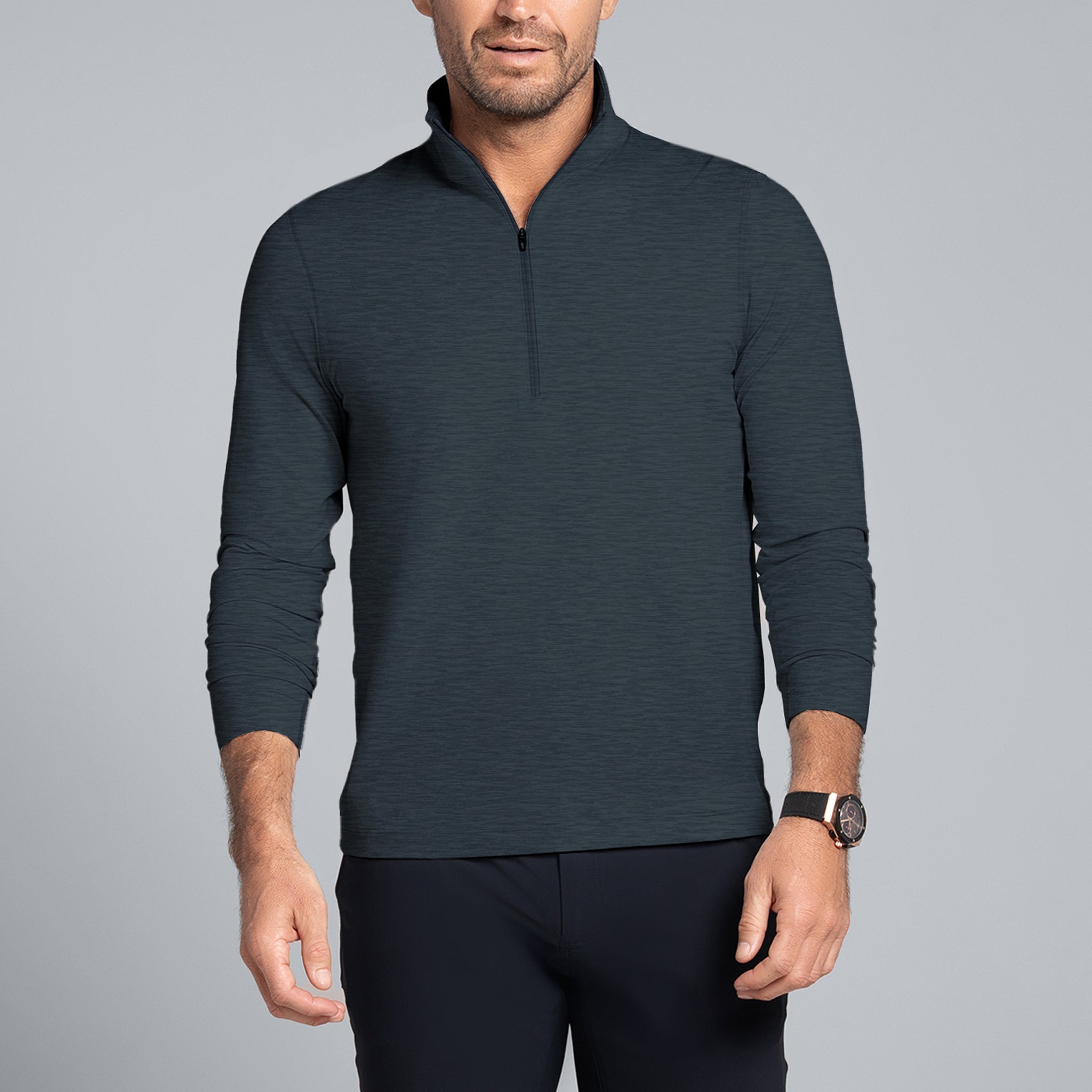 Man wearing a dark gray long-sleeve shirt and black shorts on a gray background