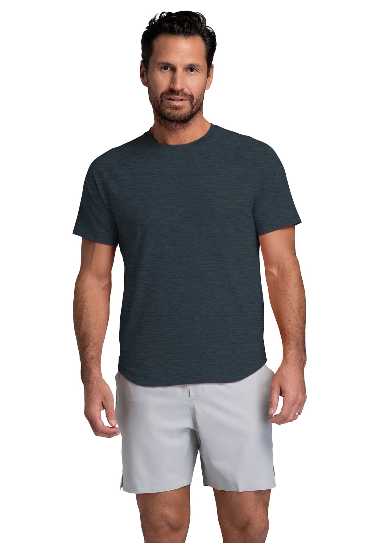 Man wearing a dark gray t-shirt and light gray shorts on a white background