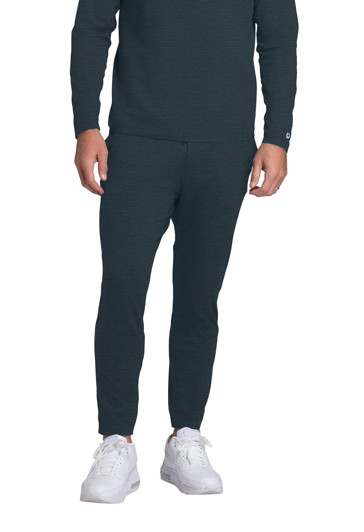 Person wearing a dark gray long-sleeve top and pants with white sneakers on a white background